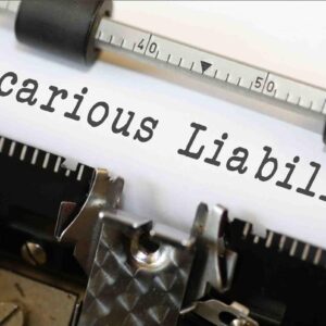 Typewriter typing 'Vicarious Liability' on paper.